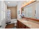Bathroom featuring a wood vanity with granite countertop, and a shower and tub combo at 241 Sapphire Lake Dr # 201, Bradenton, FL 34209