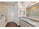 Bright bathroom featuring a dual sink vanity with granite countertop and a glass enclosed shower at 241 Sapphire Lake Dr # 201, Bradenton, FL 34209