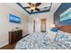 Comfortable bedroom with blue accent wall, tray ceiling, and modern decor at 241 Sapphire Lake Dr # 201, Bradenton, FL 34209