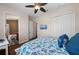 Bedroom featuring a ceiling fan, a TV, and an ensuite bathroom at 241 Sapphire Lake Dr # 201, Bradenton, FL 34209