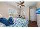 Bedroom featuring a ceiling fan, a window with white shutters, and a workspace with a desk at 241 Sapphire Lake Dr # 201, Bradenton, FL 34209