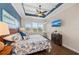 Well-appointed bedroom with blue accent wall, tray ceiling, and hardwood floors at 241 Sapphire Lake Dr # 201, Bradenton, FL 34209
