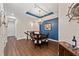 Elegant dining room features a chandelier, wood floors, and blue accent wall at 241 Sapphire Lake Dr # 201, Bradenton, FL 34209