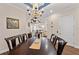 This dining room features a chandelier and open layout to other living spaces at 241 Sapphire Lake Dr # 201, Bradenton, FL 34209