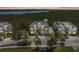 Beautiful townhouse with neutral tones, lush landscaping, and a view of the water and trees in the background at 241 Sapphire Lake Dr # 201, Bradenton, FL 34209