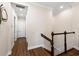 Bright hallway with beautiful wood floors, white trim, and doors leading to various rooms at 241 Sapphire Lake Dr # 201, Bradenton, FL 34209