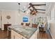 Spacious kitchen features a large island with marble countertop, pendant lights, and modern appliances at 241 Sapphire Lake Dr # 201, Bradenton, FL 34209