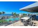 Breathtaking pool views from this shaded outdoor patio area with tables and chairs for relaxing by the pool at 241 Sapphire Lake Dr # 201, Bradenton, FL 34209
