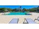 Relaxing community pool surrounded by chairs and greenery, perfect for lounging at 241 Sapphire Lake Dr # 201, Bradenton, FL 34209