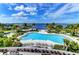Beautiful waterfront pool area with lounge chairs and palm trees overlooking the bay at 241 Sapphire Lake Dr # 201, Bradenton, FL 34209