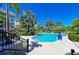 Community pool featuring lush tropical landscaping and inviting lounge seating at 241 Sapphire Lake Dr # 201, Bradenton, FL 34209