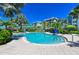Beautiful community pool with comfortable lounge chairs and tropical landscaping at 241 Sapphire Lake Dr # 201, Bradenton, FL 34209