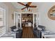 Charming sunroom with comfortable seating and a view of open floorplan with shiplap walls at 241 Sapphire Lake Dr # 201, Bradenton, FL 34209