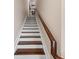 Elegant staircase featuring wood treads, white risers, and a rich wood railing at 241 Sapphire Lake Dr # 201, Bradenton, FL 34209