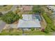 Aerial view of home with a screened-in pool, lush landscaping, and a spacious backyard at 301 Angelico Dr, Nokomis, FL 34275