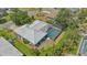 This home features a private screened-in pool, mature trees, and lush landscaping for outdoor enjoyment at 301 Angelico Dr, Nokomis, FL 34275