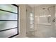 Modern shower stall with glass door, window and stylish fixtures at 301 Angelico Dr, Nokomis, FL 34275