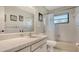 Well-maintained bathroom featuring decorative tile, vanity, and shower-tub combination, offering a clean functional space at 301 Angelico Dr, Nokomis, FL 34275
