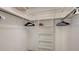 Spacious walk-in closet with built-in shelving and hanging rods for optimal storage in this home at 301 Angelico Dr, Nokomis, FL 34275