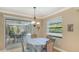 Cozy dining area leading to an outdoor lanai and screened pool, perfect for entertaining and relaxation at 301 Angelico Dr, Nokomis, FL 34275