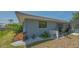 Side view of home featuring landscaped backyard, lush plants and pool area at 301 Angelico Dr, Nokomis, FL 34275