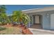 Home entrance with decorative plants, tiled entry, and storm door at 301 Angelico Dr, Nokomis, FL 34275