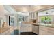 Bright kitchen with granite countertops, stainless steel appliances, and a pass-through to the living area at 301 Angelico Dr, Nokomis, FL 34275