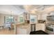 Modern kitchen featuring granite countertops, stainless steel appliances, and an adjacent breakfast nook at 301 Angelico Dr, Nokomis, FL 34275