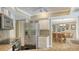 Well-equipped kitchen with stainless steel refrigerator, granite countertops, and access to the dining area at 301 Angelico Dr, Nokomis, FL 34275
