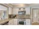 Updated kitchen featuring stainless steel appliances, granite countertops, and ample cabinet space at 301 Angelico Dr, Nokomis, FL 34275