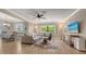 Welcoming living room with a ceiling fan, comfortable seating, and an adjacent dining area at 301 Angelico Dr, Nokomis, FL 34275