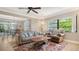 Inviting living room with a ceiling fan, comfortable seating, and a view of the dining area at 301 Angelico Dr, Nokomis, FL 34275
