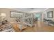 Light filled living room with dining area, wood floors, and elegant furnishings at 301 Angelico Dr, Nokomis, FL 34275