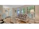 Inviting living room with wicker furnishings, large windows, and neutral decor at 301 Angelico Dr, Nokomis, FL 34275