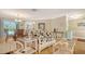Comfortable and stylish living room with dining area, bright lighting, and wood floors at 301 Angelico Dr, Nokomis, FL 34275