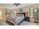 Comfortable main bedroom with a ceiling fan, lamps, and a window at 301 Angelico Dr, Nokomis, FL 34275