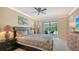 Comfortable main bedroom with a ceiling fan, lamps, and access to the screened patio at 301 Angelico Dr, Nokomis, FL 34275