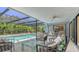 Relaxing screened-in pool area with comfortable lounge furniture, perfect for enjoying sunny days and outdoor entertaining at 301 Angelico Dr, Nokomis, FL 34275