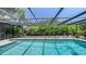 Sparkling screened-in swimming pool with lush landscaping, offering a private and refreshing outdoor experience at 301 Angelico Dr, Nokomis, FL 34275
