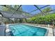 Beautiful screened-in pool surrounded by lush greenery, providing a private and relaxing outdoor retreat at 301 Angelico Dr, Nokomis, FL 34275