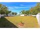 Expansive backyard with lush green grass, mature trees, and a privacy fence offering a serene outdoor retreat at 3090 6Th St, Sarasota, FL 34237