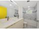 Bright bathroom features marble-look tile, modern fixtures, and a bathtub for a relaxing experience at 3090 6Th St, Sarasota, FL 34237