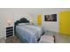 Stylish bedroom with blue accents, modern furniture, and bright yellow doors, adding a pop of color at 3090 6Th St, Sarasota, FL 34237