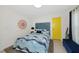 Charming bedroom with blue tones, a decorative wall hanging, and a bright yellow door at 3090 6Th St, Sarasota, FL 34237
