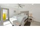 Inviting bedroom boasts a tufted headboard, plush bedding, stylish mirror, and ample natural light at 3090 6Th St, Sarasota, FL 34237