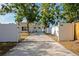 Long driveway and elegant entrance with an electric gate leading to a modern home with fresh landscaping at 3090 6Th St, Sarasota, FL 34237