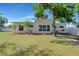 Modern home boasts a well-manicured lawn, elegant landscaping, and a white exterior with expansive windows at 3090 6Th St, Sarasota, FL 34237