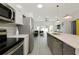 Bright modern kitchen with stainless steel appliances and an open concept design flowing into the living area at 3090 6Th St, Sarasota, FL 34237