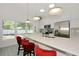 Beautiful, bright kitchen features modern countertops, stainless steel appliances, island seating, and lots of natural light at 3090 6Th St, Sarasota, FL 34237
