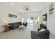 Cozy living room with gray furniture, light flooring, and sliding doors to the outdoor area at 3090 6Th St, Sarasota, FL 34237